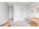 Well-lit Bedroom with crib, playmat and convenient access to closet space at 4728 Old Blush St, Bradenton, FL 34211