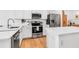 Bright kitchen with stainless steel appliances, white countertops, and hardwood floors at 4728 Old Blush St, Bradenton, FL 34211