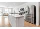 Bright, open kitchen with stainless steel appliances, modern white cabinets, and center island at 4728 Old Blush St, Bradenton, FL 34211