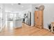Bright, open floor plan with kitchen island, stainless appliances, and light wood flooring at 4728 Old Blush St, Bradenton, FL 34211