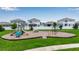 Community playground with swings, slides, and play equipment, a great place for to play at 4728 Old Blush St, Bradenton, FL 34211