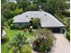 Aerial view of a well-maintained home with lush landscaping and a brick driveway at 4761 Pine Harrier Dr, Sarasota, FL 34231