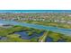 Breathtaking aerial view showcasing waterfront homes, lush mangroves, and the ocean in the background at 4761 Pine Harrier Dr, Sarasota, FL 34231