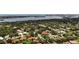 Scenic aerial view showing a waterfront neighborhood with mature trees, manicured landscaping, and water view at 4761 Pine Harrier Dr, Sarasota, FL 34231