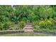 Tranquil backyard with lush landscaping and brick retaining wall at 4761 Pine Harrier Dr, Sarasota, FL 34231