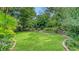 Manicured lawn in backyard with flower beds and retaining wall at 4761 Pine Harrier Dr, Sarasota, FL 34231