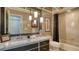 Bathroom with a framed mirror, vanity with a granite countertop, and a shower/tub combo at 4761 Pine Harrier Dr, Sarasota, FL 34231