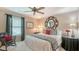 Comfortable bedroom with a cozy chair, decorative mirror, and ample natural light at 4761 Pine Harrier Dr, Sarasota, FL 34231