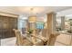 Elegant dining room featuring a glass-top table, patterned chairs, and a stylish chandelier at 4761 Pine Harrier Dr, Sarasota, FL 34231