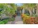 Beautiful home with lush landscaping, a brick walkway and decorative front door at 4761 Pine Harrier Dr, Sarasota, FL 34231