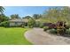 Well-maintained home features lush landscaping and a brick driveway at 4761 Pine Harrier Dr, Sarasota, FL 34231