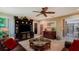 Inviting living room with a ceiling fan, a large entertainment center and comfortable seating at 4761 Pine Harrier Dr, Sarasota, FL 34231