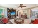Comfortable living room with a large entertainment center, leather sofa and neutral colored walls at 4761 Pine Harrier Dr, Sarasota, FL 34231