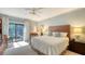 Serene main bedroom with a plush bed, private access to the screened lanai and lots of natural light at 4761 Pine Harrier Dr, Sarasota, FL 34231