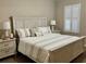 Comfortable bedroom features neutral walls, carpet floors, and a light wood accent wall at 500 San Lino Cir # 534, Venice, FL 34292