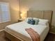 Cozy bedroom with a large bed, neutral walls, and a window with plantation shutters at 500 San Lino Cir # 534, Venice, FL 34292