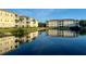 Beautiful condo community with lake reflecting buildings on a sunny day at 500 San Lino Cir # 534, Venice, FL 34292