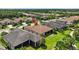 Aerial view of the house showcasing its tile roof, screened lanai, and well-manicured lawn at 5104 Benito Ct, Bradenton, FL 34211