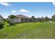 Spacious backyard featuring a well-maintained lawn and landscaping, perfect for outdoor activities and relaxation at 5104 Benito Ct, Bradenton, FL 34211
