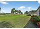 Expansive backyard featuring lush lawn and colorful flowers, perfect for outdoor enjoyment and relaxation at 5104 Benito Ct, Bradenton, FL 34211