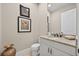 Bathroom featuring a granite vanity, framed art, and a toilet with white cabinets at 5104 Benito Ct, Bradenton, FL 34211