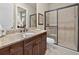 Bathroom featuring a granite countertop with a glass-enclosed shower and natural light at 5104 Benito Ct, Bradenton, FL 34211