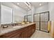 Bathroom features a granite countertop with dual sinks and a large glass-enclosed shower at 5104 Benito Ct, Bradenton, FL 34211