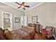 Bedroom with ceiling fan, complemented by hardwood floors, and an attached bathroom at 5104 Benito Ct, Bradenton, FL 34211