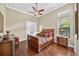 Comfortable bedroom boasting a ceiling fan and hardwood floors, complemented by a window and nightstands at 5104 Benito Ct, Bradenton, FL 34211