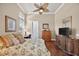 Comfortable bedroom featuring a ceiling fan and a workspace with a desk and a plush bed at 5104 Benito Ct, Bradenton, FL 34211
