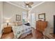 Comfortable bedroom with hardwood floors, natural light, and a charming decor at 5104 Benito Ct, Bradenton, FL 34211
