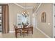 Cozy dining room with wood table, chandelier, and large window providing natural light at 5104 Benito Ct, Bradenton, FL 34211