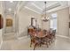 Elegant dining room with a large wood table, chandelier, and tray ceiling at 5104 Benito Ct, Bradenton, FL 34211