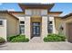 Elegant front entrance featuring a double door entry, stone pillars, and manicured landscaping at 5104 Benito Ct, Bradenton, FL 34211