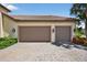 Spacious three-car garage with a brick-paved driveway, offering ample parking and storage space at 5104 Benito Ct, Bradenton, FL 34211