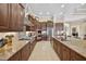 Gourmet kitchen with granite countertops, stainless steel appliances, and custom cabinetry at 5104 Benito Ct, Bradenton, FL 34211