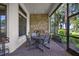 Outdoor dining space with a built-in grill on the screened-in lanai perfect for entertaining at 5104 Benito Ct, Bradenton, FL 34211