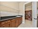 Laundry area featuring a sink, cabinets, countertops, and wire shelving for storage at 5104 Benito Ct, Bradenton, FL 34211