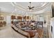 Open-concept living room, dining, and kitchen area with tile floors and coffered ceilings at 5104 Benito Ct, Bradenton, FL 34211