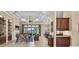 Open concept living space features stylish furnishings, tray ceiling, built ins, and access to lanai with a beautiful view at 5104 Benito Ct, Bradenton, FL 34211