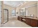 Luxurious main bathroom featuring a walk-in shower, soaking tub, and dual vanities at 5104 Benito Ct, Bradenton, FL 34211