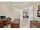 Office space featuring a desk, wood floors and a view of a living area through french doors at 5104 Benito Ct, Bradenton, FL 34211