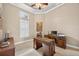 Well-lit office with hardwood desk and a shuttered window, complemented by neutral colors at 5104 Benito Ct, Bradenton, FL 34211