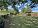 Spacious backyard with partial fencing and large trees, offering ample space for outdoor activities at 5350 Barbarossa Ave, Sarasota, FL 34235