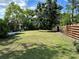Large backyard with a shed, screen lanai, and wooden fence at 5350 Barbarossa Ave, Sarasota, FL 34235