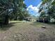 Large backyard with mature trees, a shed, and partial fencing, providing a private and versatile outdoor area at 5350 Barbarossa Ave, Sarasota, FL 34235