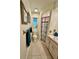 Bathroom features tiled floors, toilet, shower with curtain, cabinets, and a large window at 5350 Barbarossa Ave, Sarasota, FL 34235