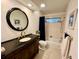 Bathroom with a vanity sink, a large mirror, and shower-tub combo at 5350 Barbarossa Ave, Sarasota, FL 34235