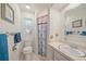 Bright bathroom featuring a shower, tile flooring, vanity, mirror, and blue accents at 5350 Barbarossa Ave, Sarasota, FL 34235