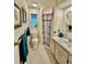 Cozy bathroom features tiled floors, decorative shower curtain and lovely art adorning the walls at 5350 Barbarossa Ave, Sarasota, FL 34235